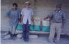 men with bags of soybean seeds